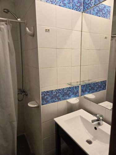 a bathroom with a sink and a mirror at Devoto Hotel Boutique in Buenos Aires