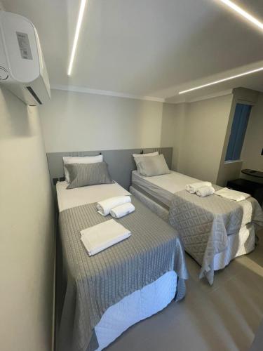 a room with two beds and a tv at Troodon Park Hotel in Sousa