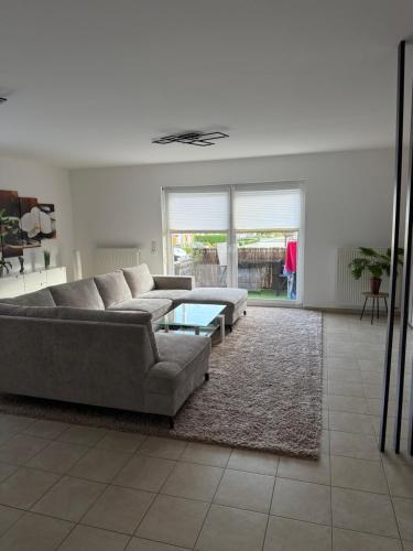 a living room with a couch and a table at Modernes Apartment in Orscholz in Mettlach