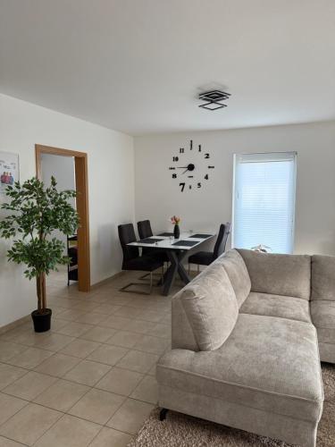a living room with a couch and a table at Modernes Apartment in Orscholz in Mettlach