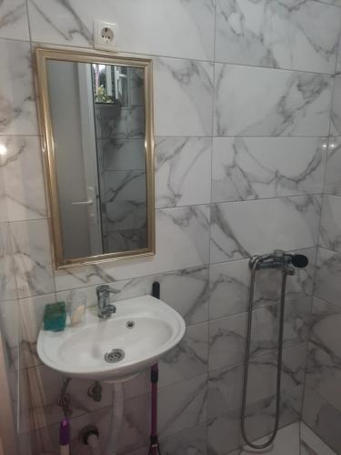 a white bathroom with a sink and a mirror at Hris-An in Star Dojran