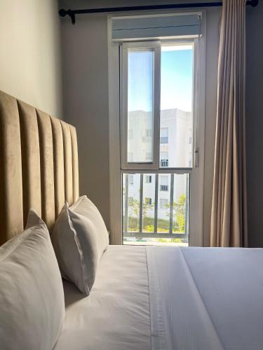 a bedroom with a bed with a large window at Diplomatic Forest - CHU Family Apartment in Hajreien