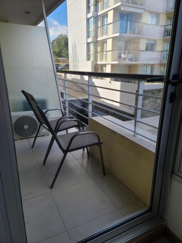 a pair of chairs sitting on a balcony at Apart Altos del Virrey in Colonia del Sacramento