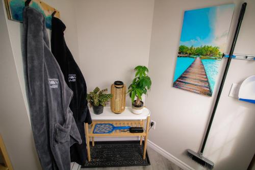 a bathroom with a table and a picture of a boat at Island Beach Hideaways in Pomquet