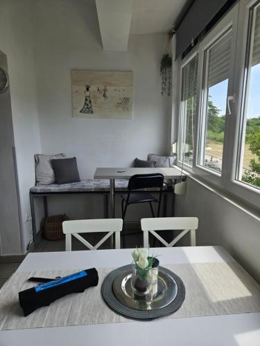 a room with a table and chairs and a bed at Pipo Apartment Mareda in Novigrad Istria