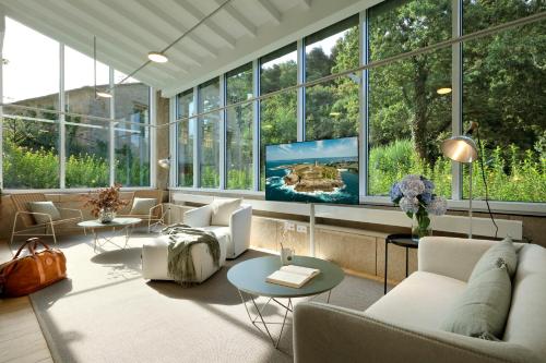 a living room with a lot of windows at Casas do Sarela by Upper Luxury Housing in Santiago de Compostela