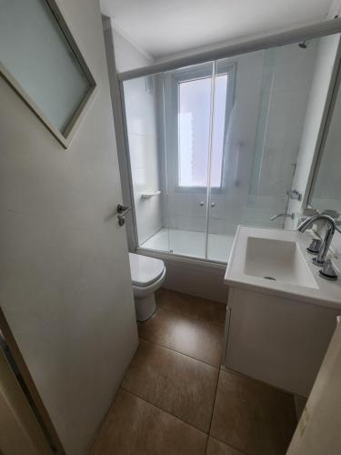 a bathroom with a sink and a toilet and a window at Plaza López in Rosario