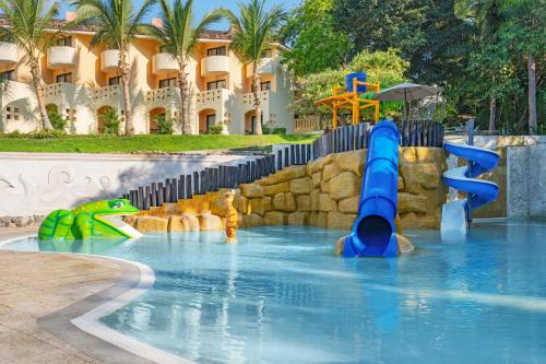 a water slide in a pool at a resort at Grand Palladium Vallarta Resort & Spa - All Inclusive in Punta Mita