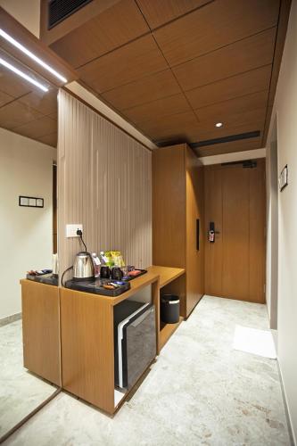 a kitchen with a counter and a stove top oven at Grand Continent Dwarka in Dwarka