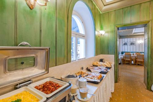 a buffet line with many different types of food at Aparthotel Tři lilie in Františkovy Lázně