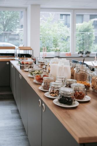 a kitchen counter with plates of food on it at Europa-Haus-Bocholt - Bett & Bike in Bocholt