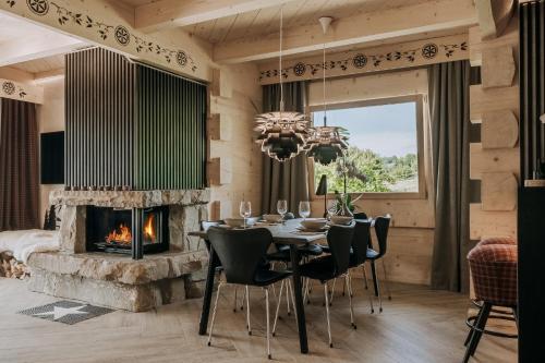 a dining room with a table and a fireplace at Tatra Bjerge View in Zakopane