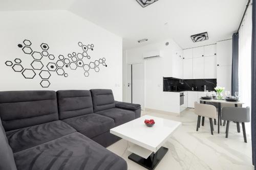 a living room with a couch and a table at Amber Baltic Apartment by Solarento in Niechorze