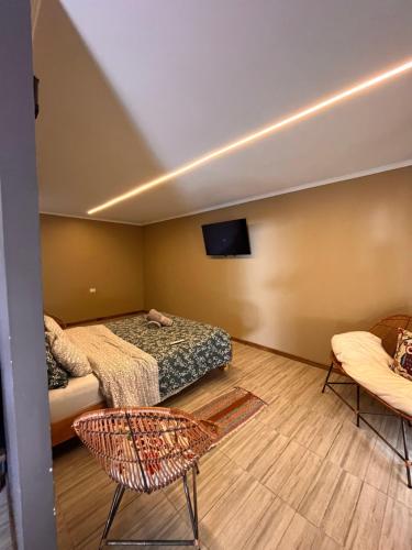 a room with two beds and a flat screen tv at Casa de campo matrimonial in Choshuenco