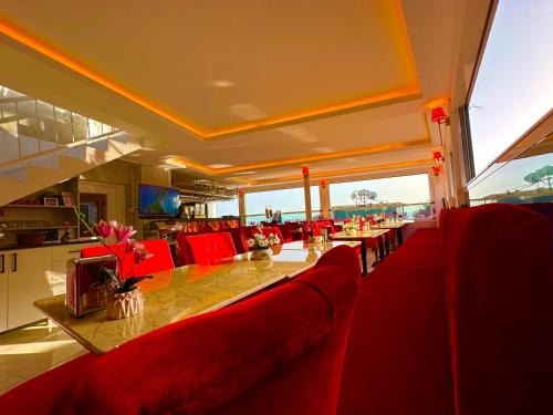 a restaurant with a long table and red chairs at Ayasofya Hotel - Special Class in Istanbul