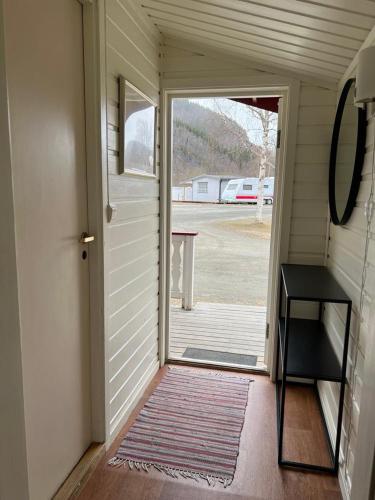 an open door to a porch with a table at Nordnes Kro og Camping in Rokland