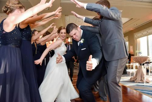 a bride and groom dancing in front of their wedding party at DoubleTree by Hilton New Orleans in New Orleans