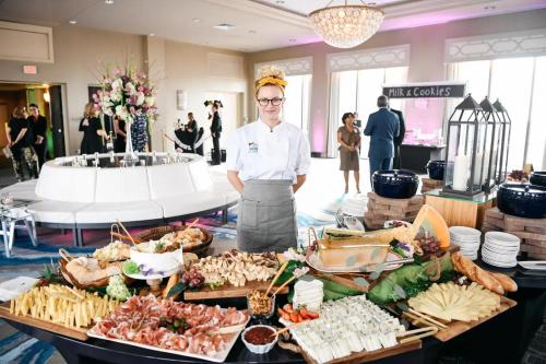 a woman standing in front of a buffet of food at DoubleTree by Hilton New Orleans in New Orleans