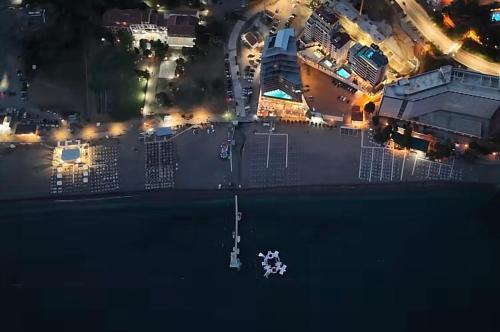 an aerial view of a boat in the water at night at Hotel Ponta Plaza Conference & Spa in Budva