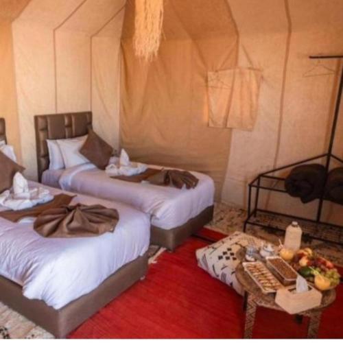 Ένα ή περισσότερα κρεβάτια σε δωμάτιο στο Merzouga wonderful camp