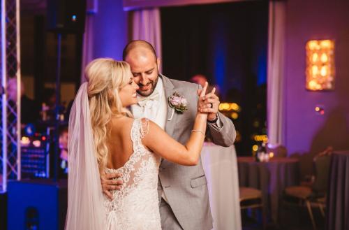 a bride and groom dancing at their wedding reception at DoubleTree by Hilton New Orleans in New Orleans