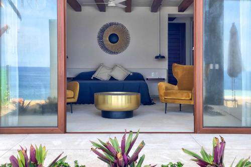 a living room with a bed and a coffee table at Casa Celeste in Troncones