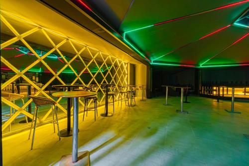 a room with tables and chairs and green lights at May Termal Pamukkale in Pamukkale