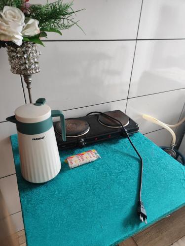 a blue table with a coffee mug and a drink at Campo Lara Pousada in Campo Mourão