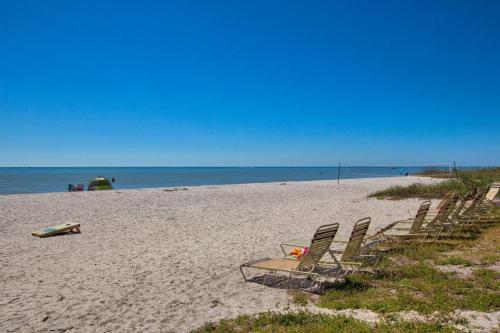 a group of chairs sitting on a beach at Pointe Santo B32 condo in Sanibel