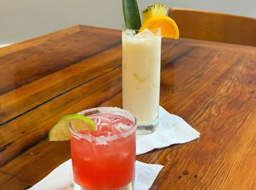 two cocktails sitting on a wooden table at DoubleTree by Hilton New Orleans in New Orleans