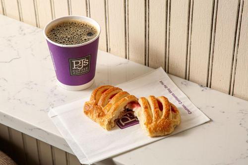 a sandwich and a cup of coffee on a table at DoubleTree by Hilton New Orleans in New Orleans