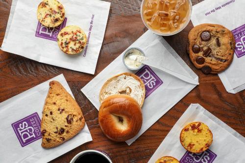 a table topped with different types of bread and pastries at DoubleTree by Hilton New Orleans in New Orleans