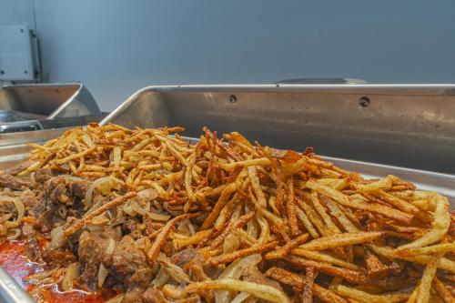 a pile of french fries and meat in a pan at May Termal Pamukkale in Pamukkale