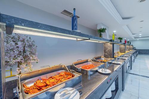 a buffet line with many trays of food at May Termal Pamukkale in Pamukkale