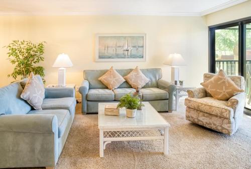 a living room with couches and a coffee table at Pointe Santo D27 condo in Sanibel