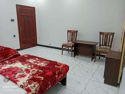 a living room with a couch and two chairs at Bijarani Guest House in Mīrpur Khās