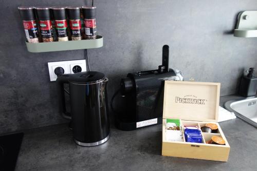 a kitchen counter with a coffee maker and a box of donuts at Apartmán HARMONY - Lipno nad Vltavou in Lipno nad Vltavou