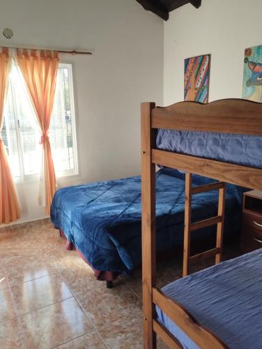 a bedroom with two bunk beds and a window at Entrecalandrias in Colón