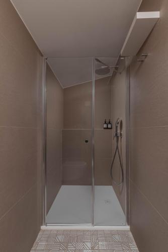a shower with a glass door in a bathroom at Villa Alea Hvar in Hvar
