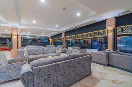 a waiting room with couches and tables in a building at May Termal Pamukkale in Pamukkale