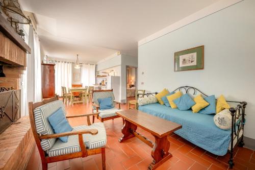 a living room with a blue couch and a table at Agriturismo Lemene in Caorle