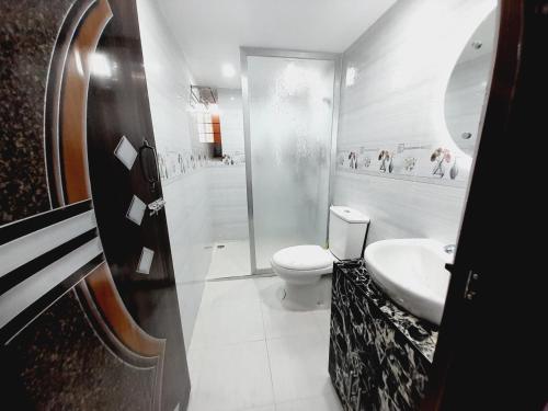 a bathroom with a toilet and a shower and a sink at Hill View Tower, Sylhet, Shah Poran, Sylhet in Debpur