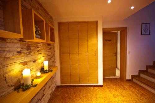 a hallway with two candles and a closet with stairs at Landhaus Zaglauhof in Werfenweng