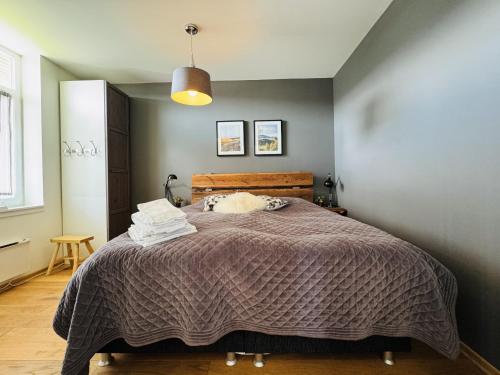 a bedroom with a bed with a blanket at Stay in central Geilo, 3 bedrooms, linen and towels included in Geilo
