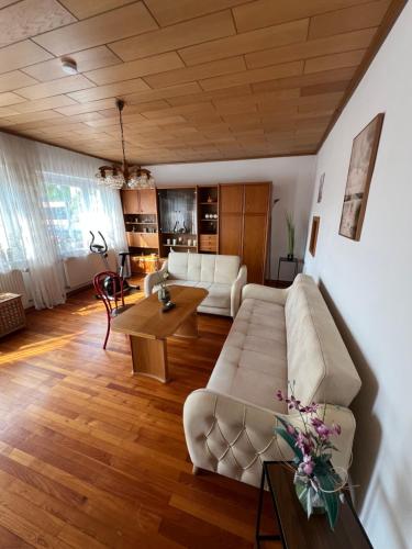 a living room with a couch and a table at Ferienhaus Limes Carnuntum mit Terrasse und Garten in Petronell