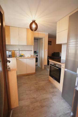 a kitchen with white cabinets and a stove at Kosmajko in Koraćica
