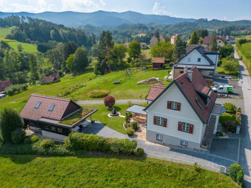 an aerial view of a house in a village at das "Ferienhaus Eibiswald" Landhaus Refugium im Schilcherland - Sauna und Spa in Eibiswald
