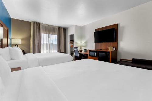 a hotel room with two beds and a flat screen tv at Comfort Inn & Suites Augusta West Near Fort Eisenhower in Augusta