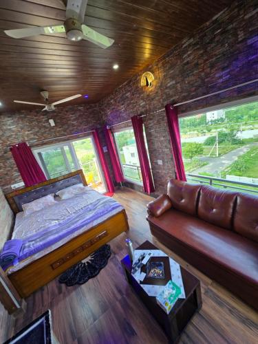 a bedroom with a bed and a couch in a room at Barla's Home Stay in Hyderabad