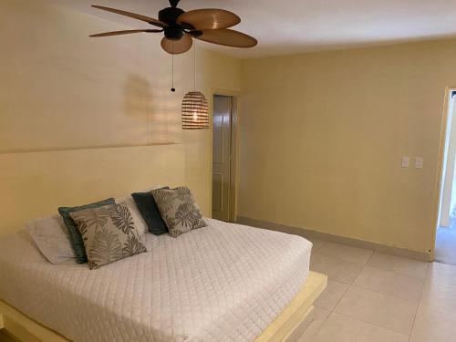 a bedroom with a bed with a ceiling fan at Gardenia Springs - La Finca Buritaca in Buritaca